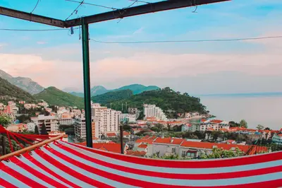 a red and white hammock overlooking a city at Apartman Lana in Petrovac na Moru