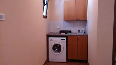 a kitchen with a washing machine and a counter at Villa Budvanka Guesthouse in Budva