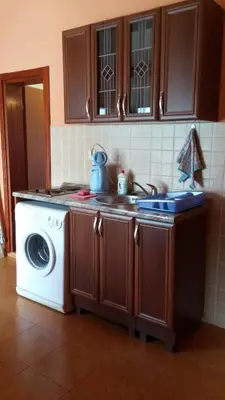 a kitchen with a sink and a washing machine at Villa Budvanka Guesthouse in Budva
