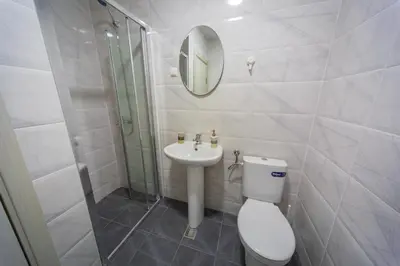 a bathroom with a toilet and a sink and a mirror at SUN apartment in Podgorica