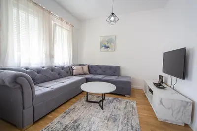 a living room with a couch and a table at Blue moon apartment in Podgorica