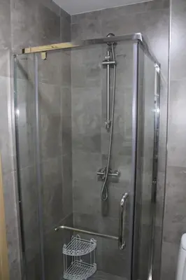 a shower with a glass door in a bathroom at Lovely apartment - Ljupki stan in Podgorica