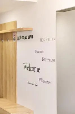 a wall with the names of different languages on it at Lux Hotel M in Dobra Voda