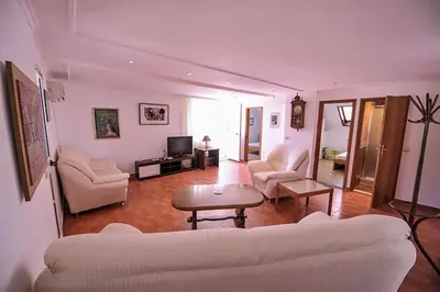 a living room with a couch and a table at Vila Mila in Petrovac na Moru