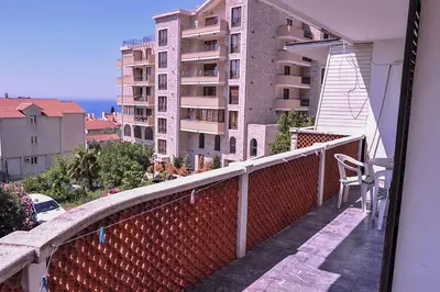 a balcony with a view of a building at Vila Mila in Petrovac na Moru