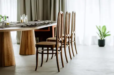 a dining room table with four chairs and a table at Hotel Septembar in Podgorica
