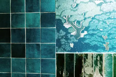 a tile wall with a painting of a tree at Hotel Septembar in Podgorica