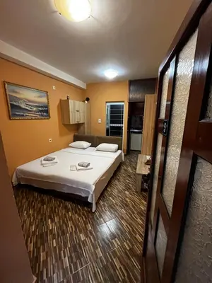 a hotel room with a bed and a kitchen at Puerta Apartments in Kotor