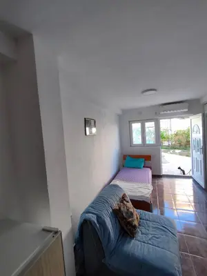 a room with two beds and a couch in it at Apartment Panorama in Bar