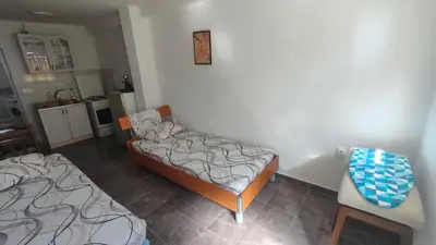 a living room with two beds and a kitchen at Apartment Panorama in Bar