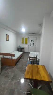 a room with two beds and a table in it at Apartment Panorama in Bar