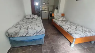 two beds sitting next to each other in a room at Apartment Panorama in Bar