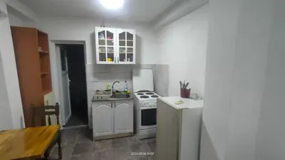 a small kitchen with a stove and a refrigerator at Apartment Panorama in Bar