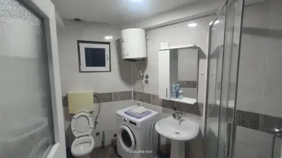 a bathroom with a sink and a toilet and a shower at Apartment Panorama in Bar