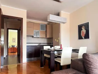 a dining room and kitchen with a table and chairs at Lana apartment Petrovac in Petrovac na Moru