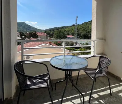 a table and chairs on a balcony with a view at Lana apartment Petrovac in Petrovac na Moru