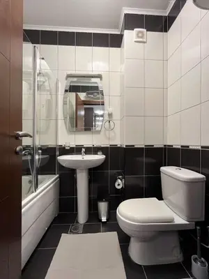 a bathroom with a toilet and a sink and a tub at Lana apartment Petrovac in Petrovac na Moru