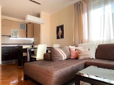 a living room with a couch and a table at Lana apartment Petrovac in Petrovac na Moru