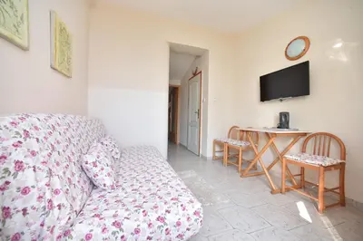 a living room with a couch and a table at Apartment Plazza Rafailovici in Rafailovici