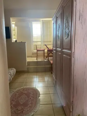 a hallway with a door and a table and chairs at Apartment Plazza Rafailovici in Rafailovici