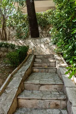 a set of stone steps leading up to a house at Vila Hrastovi in Sutomore