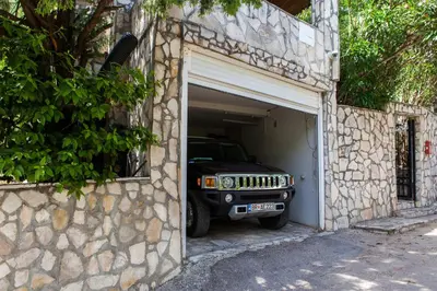 a jeep is parked inside of a garage at Vila Hrastovi in Sutomore