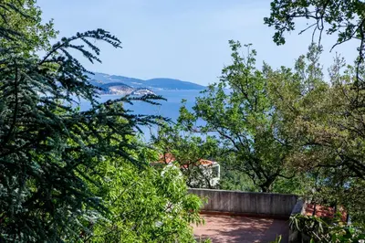 a view of the water from a house with trees at Vila Hrastovi in Sutomore