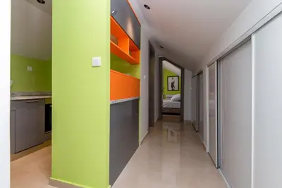 a hallway in a house with green and orange walls at apartman365kotor in Kotor