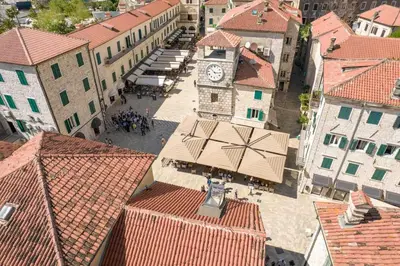 an overhead view of a town with a clock tower at apartman365kotor in Kotor
