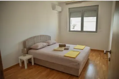 a bedroom with a bed with two towels on it at Sofija in Ulcinj
