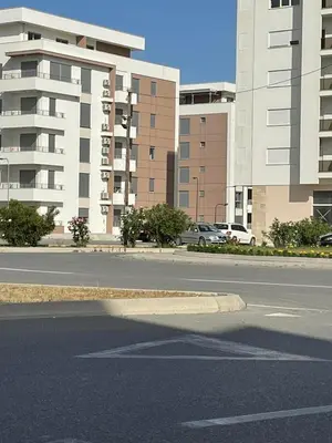 an empty street in a city with tall buildings at Sofija in Ulcinj
