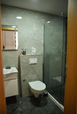 a bathroom with a shower and a toilet and a sink at Sofija in Ulcinj