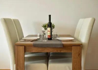 a wooden table with a bottle of wine on it at Sofija in Ulcinj