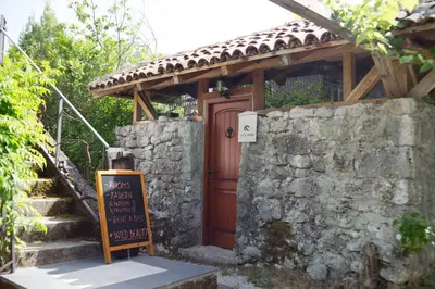 a stone building with a sign in front of it at Lucha apartman in Rijeka Crnojevića