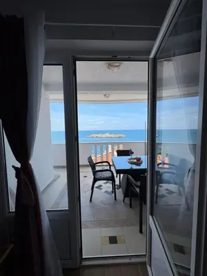 a room with a table and a view of the ocean at Pine&Sea Beach Retreat in Sveti Stefan