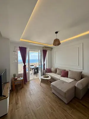 a living room with a couch and a view of the ocean at Pine&Sea Beach Retreat in Sveti Stefan
