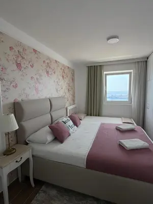 a bedroom with a large bed and a window at Pine&Sea Beach Retreat in Sveti Stefan