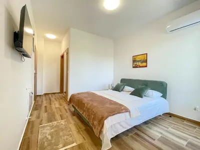 a bedroom with a bed and a television in it at MaNora in Ulcinj