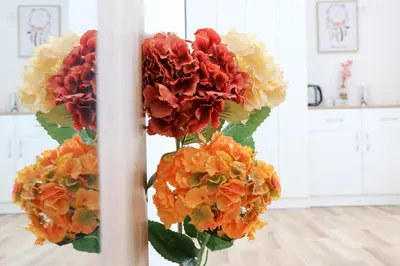 a vase filled with fake flowers in a room at MaNora in Ulcinj
