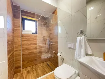 a bathroom with a shower and a toilet and a sink at MaNora in Ulcinj