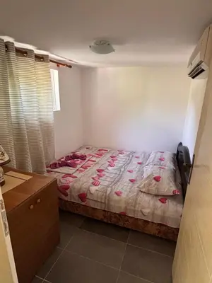 a bedroom with a bed with pink flowers on it at Vikendica Nina in Čanj