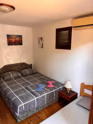 a bedroom with a bed with two stuffed animals on it at Vikendica Nina in Čanj