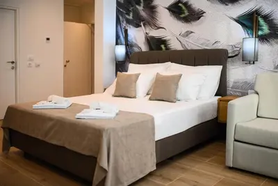 a bedroom with a bed with two towels on it at G Star Hotel in Sutomore