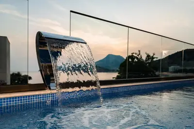 a water fountain in a swimming pool with a view at G Star Hotel in Sutomore