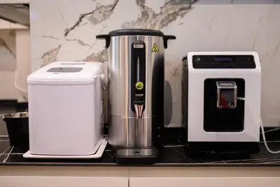 a coffee maker sitting on a counter next to a appliance at G Star Hotel in Sutomore