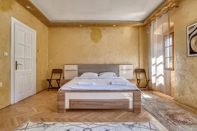 a bedroom with a large bed in a room at Stone Home Kotor in Dobrota