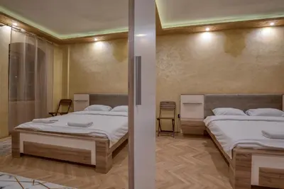 two beds in a room with two beds sidx sidx sidx sidx at Stone Home Kotor in Dobrota