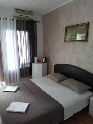 a bedroom with a large bed with two plates on it at Room Rada in Ulcinj