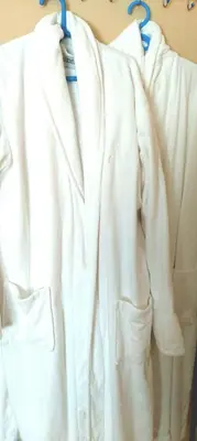 a group of white clothes hanging on a rack at Room Rada in Ulcinj