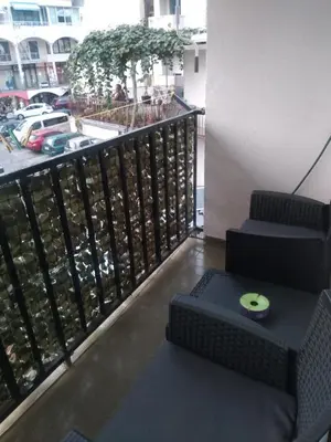 a balcony with a chair and stairs with a view of a city at Room Rada in Ulcinj